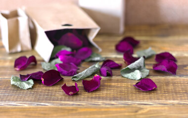 Dried  rose petals on wooden background 