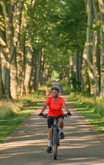 Naklejka premium attractive senior woman cycling with her electric mountain bike in the city park of Stuttgart, Baden-Wuerttemberg, Germany