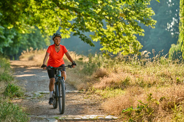 Fototapeta na wymiar attractive senior woman cycling with her electric mountain bike in the city park of Stuttgart, Baden-Wuerttemberg, Germany