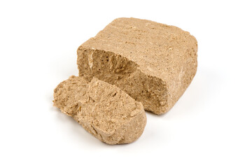 Pieces of sunflower halva, isolated on white background.