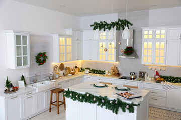 Cozy spacious kitchen decorated for Christmas. Interior design