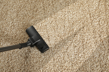 Hoovering carpet with vacuum cleaner, above view and space for text. Clean trace on dirty surface