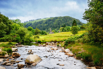 Idyllic view in Glendalough Valley, County Wicklow, Ireland. Mountains, lake and tourists walking paths