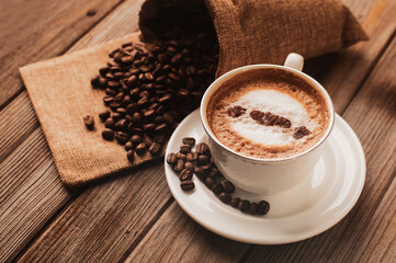 Roasted Coffee Bean in Fresh, Hot Cappuccino on Wooden Saucer