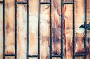 Old metal wooden door. Background of metal door with wood inside.