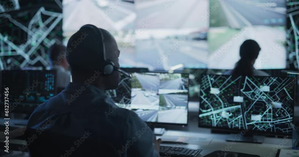 Poster Multicultural Surveillance Specialists Work in a Dark Monitoring Room. Officers Track Target from Satellite on Computers. Software Developer Using Laptop in High-Tech Cybersecurity Office