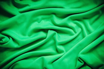 Green wrinkled fabric texture. Close-up of soft cotton cloth, may be used as background.