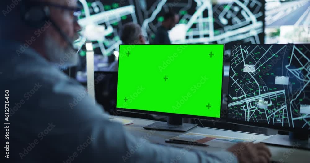 Poster Middle Aged Surveillance Specialist Working on a Computer with Green Screen Mock Up Display. Manager Effectively Multitasking with Supporting Clients on a Phone Call and Computer Work
