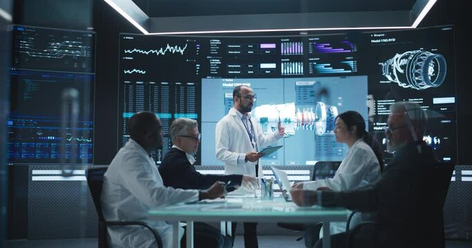 Team of Industrial Engineers Having a Meeting in a Research and Development Science Laboratory. Diverse Group of Professionals Discussing New Turbine Design on Big Digital Screen