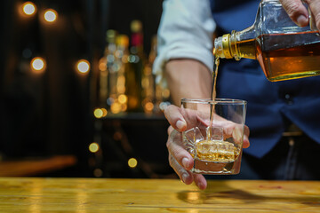 Bartender pouring Whiskey, on  bar,