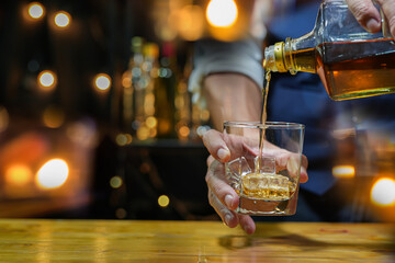 
Bartender pouring Whiskey, on  bar