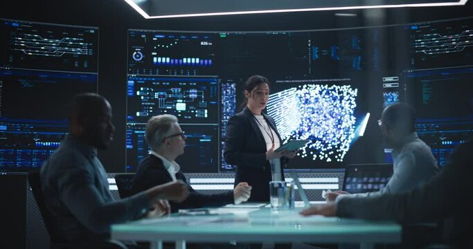 International Artificial Intelligence Research and Development Company Working on a New Generative AI Tool. Female Manager Having a Meeting with Computer Engineers in a Room with Big Digital Screen