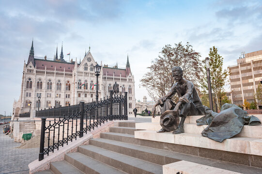 Poet Attila Jozsef statue in Budapest, Hungary, Parliament in Background