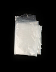 Folded White Plastic Bags on Black Background, Crumpled Plastic Bag after Shopping, Cellophane Packaging Waste