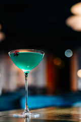 alcoholic cocktail in a glass stands on a table in a bar or restaurant