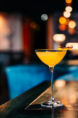 alcoholic cocktail in a glass stands on a table in a bar or restaurant