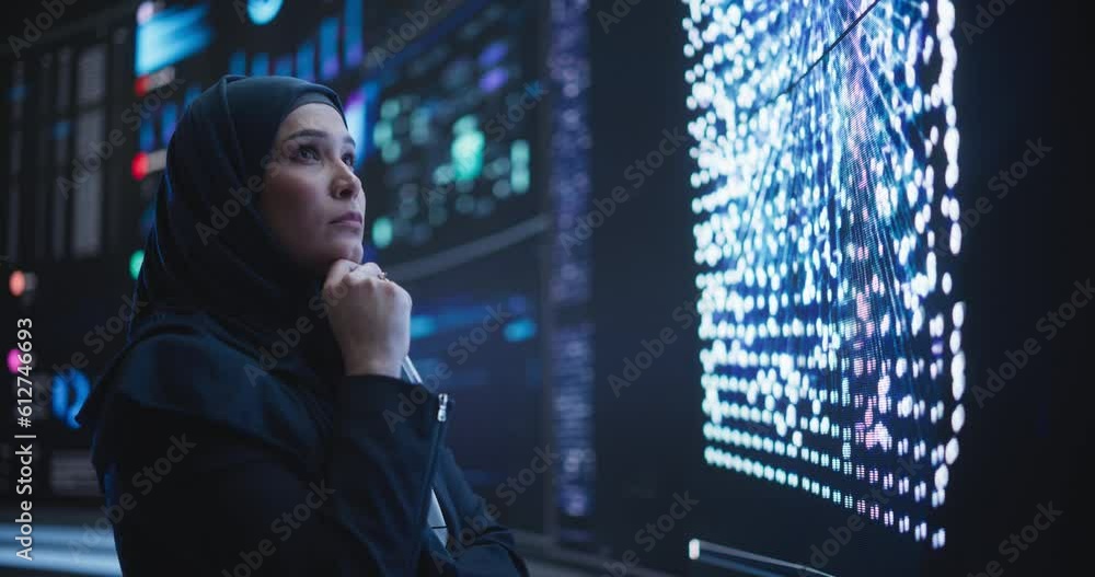 Fototapete Portrait of a Thoughtful Middle Eastern Software Developer Working in Technological Corporate Office. Young Woman Testing Artificial Intelligence Algorithms for an Innovative Internet Project