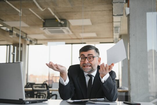 Angry businessman with document shouting at somebody