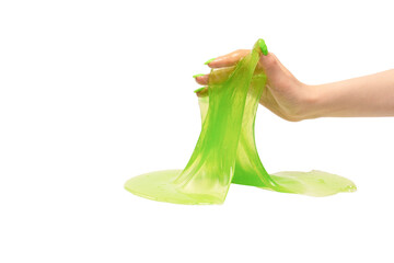 Green slime toy in woman hand with green nails isolated on a white background.