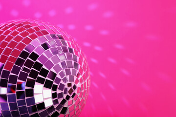 Shiny disco ball on pink background, closeup. Space for text