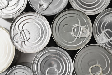 Many closed tin cans as background, top view