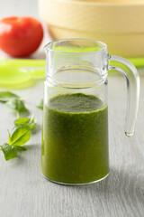 Glass can with homemade basil oil close up