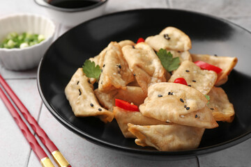 Delicious gyoza (asian dumplings) in bowl on table