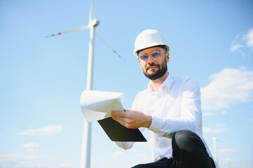 Engineer working at alternative renewable wind energy farm - Sustainable energy industry concept