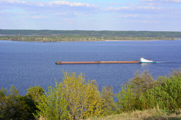 freight ship on the river isolated, view from top of the hill 