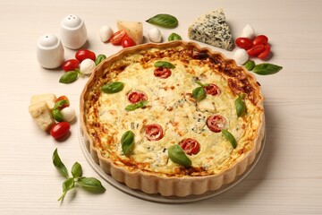 Delicious homemade cheese quiche and ingredients on wooden table