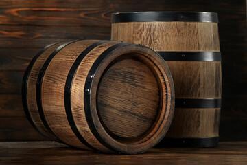 Two wooden barrels on table near wall, closeup