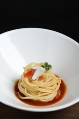 Tasty spaghetti with sauce on wooden table, closeup. Exquisite presentation of pasta dish