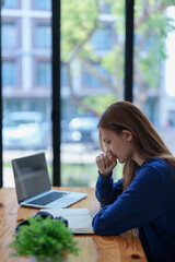 burnout, worried,serious latin girl college student watching distance online learning class, university webinar or having talk on laptop video call and use notebook to virtual meeting at living room.