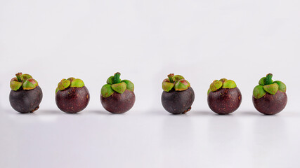 Queen of Fruit in Thailand. Fresh mangosteen fruit and half mangosteen isolated on white background. Close-up 