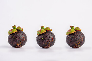 Queen of Fruit in Thailand. Fresh mangosteen fruit and half mangosteen isolated on white background. Close-up 