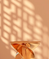 Orange chrome modern design spiral podium table in sunlight, Chinese round window grill shadow on...