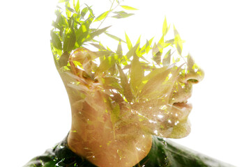 Double exposure profile portrait of a man with green branches