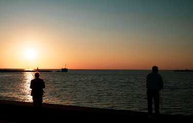 Silhouette anglers fishing at Malmo horbor
