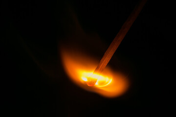Burning match in the dark. Close up view.