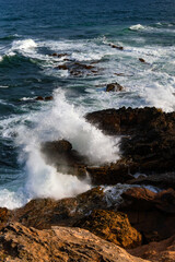 “Hell Headland“ or “La pointe d’Enfer“ with strong powerful waves on Atlantic coast of Martinique, Lesser Antilles. Waves breaking on wild rocky coast of caribbean peninsula with hiking trail. 