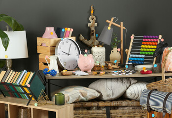 Many different items near grey wall. Garage sale