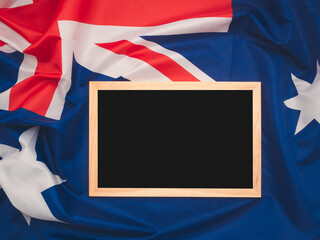 Top view of a mini chalkboard over the Australia flag background.