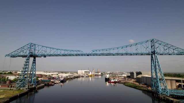 Drone flies back from Transporter Bridge whilst ascending. Shot on a sunny spring morning in Middlesbrough 