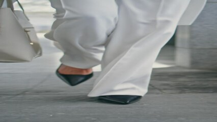 Stylish woman legs walking office in heels vertically closeup. Girl feet going