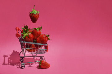 ripe strawberries in a shopping cart. fresh berry. background for the design