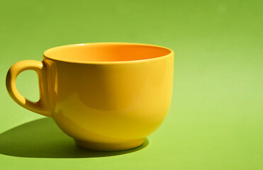 yellow tea mug. ceramic tableware. background for the design.