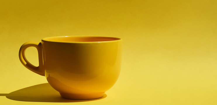 yellow tea mug. ceramic tableware. background for the design.