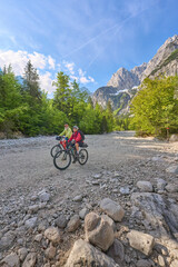 active senior couple on a mountain bike tour in the Julian Alps above Kranska Gora in Slovenia
