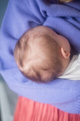 Mother breastfeeding baby, rear view. Woman with baby.