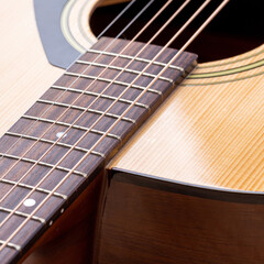 Obraz premium Classical guitar close up. Acoustic guitar on wood background.Music instrument concept
